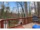 Deck overlooking backyard with wooded view and chair at 1919 Crooked Creek Dr, Charlotte, NC 28214