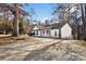 White house with red door and driveway, nestled among trees at 1919 Crooked Creek Dr, Charlotte, NC 28214