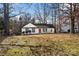 Front yard view of a white house with red door and landscaping at 1919 Crooked Creek Dr, Charlotte, NC 28214