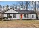 House exterior with white siding, red door, and landscaping at 1919 Crooked Creek Dr, Charlotte, NC 28214
