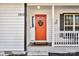 Inviting red front door with wreath, welcome mat, and white trim at 1919 Crooked Creek Dr, Charlotte, NC 28214