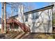 Rear view of house with deck, stairs, and wooded area at 1919 Crooked Creek Dr, Charlotte, NC 28214
