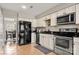 Kitchen boasts black refrigerator and stainless steel appliances at 1919 Crooked Creek Dr, Charlotte, NC 28214