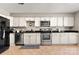 Modern kitchen with stainless steel appliances and white cabinets at 1919 Crooked Creek Dr, Charlotte, NC 28214