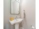 Modern powder room with pedestal sink and green framed mirror at 2401 Euclid Ave # 302, Charlotte, NC 28203