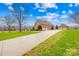 Brick house with attached garage and expansive driveway, surrounded by a lush lawn at 2510 Burton Estates Ln, Lincolnton, NC 28092