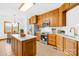 Kitchen with island, stainless steel appliances, and wood cabinets at 2510 Burton Estates Ln, Lincolnton, NC 28092
