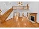 Grand living room with hardwood floors, staircase, and fireplace at 2510 Burton Estates Ln, Lincolnton, NC 28092