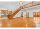 Open living space with hardwood floors, kitchen, and staircase at 2510 Burton Estates Ln, Lincolnton, NC 28092