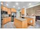 Kitchen features granite island, stainless steel appliances, and light wood cabinets at 3613 Savannah Way, Monroe, NC 28110