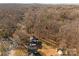 Aerial view showing house, lot, and surrounding trees at 5400 Larewood Dr, Charlotte, NC 28215