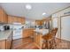 Kitchen with wood cabinets, an island, and stainless steel appliances at 6470 Long Branch Rd, Salisbury, NC 28147