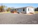 Home exterior showcasing a gravel driveway and landscaping at 816 Perry Rd, Troutman, NC 28166
