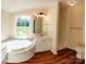 Modern bathroom featuring a garden tub, vanity, and a shower at 816 Perry Rd, Troutman, NC 28166