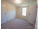 Well-lit bedroom featuring neutral walls and carpeting at 816 Perry Rd, Troutman, NC 28166