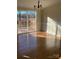 Sunlit dining room with hardwood floors and sliding glass doors to deck at 816 Perry Rd, Troutman, NC 28166