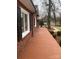Red brick home with a long tiled side porch at 936 N 5Th St, Albemarle, NC 28001