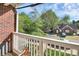 View from balcony shows charming neighborhood homes and tree-lined streets at 1420 W 4Th St, Charlotte, NC 28208