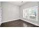 Bright bedroom with dark hardwood floors and window blinds at 1420 W 4Th St, Charlotte, NC 28208