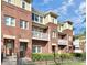 Three-story brick townhome community with balconies and landscaping at 1420 W 4Th St, Charlotte, NC 28208