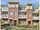 Brick townhome with 3 levels, balconies, and a fenced yard at 1420 W 4Th St, Charlotte, NC 28208