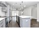 Modern kitchen features island, stainless steel appliances, and gray cabinets at 1420 W 4Th St, Charlotte, NC 28208