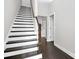 Elegant staircase with dark wood accents and white risers at 1420 W 4Th St, Charlotte, NC 28208