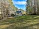 Large backyard with sprawling lawn and wooded backdrop at 250 Kenway Loop, Mooresville, NC 28117