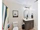 Bathroom with gray vanity, arched mirror, and colorful shower curtain at 250 Kenway Loop, Mooresville, NC 28117