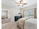 Bedroom with plush carpet, window with blinds, and access to additional room at 250 Kenway Loop, Mooresville, NC 28117