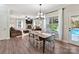 Casual dining area with wood table and chairs, open to living room and pool view at 250 Kenway Loop, Mooresville, NC 28117