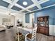 Bright dining room features a coffered ceiling, hardwood floors, and view to living room at 250 Kenway Loop, Mooresville, NC 28117