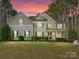 Two-story house exterior at dusk with lovely landscaping at 250 Kenway Loop, Mooresville, NC 28117