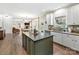 Modern kitchen boasts a large island, white cabinets, and stylish backsplash at 250 Kenway Loop, Mooresville, NC 28117