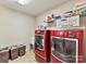 Laundry room with red washer and dryer and storage at 250 Kenway Loop, Mooresville, NC 28117