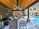 Relaxing poolside patio with covered seating area and built-in grill at 250 Kenway Loop, Mooresville, NC 28117