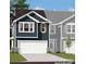 Two-story home with a gray exterior, white garage door, and landscaping at 6413 Mallow Crossing Lane Ln, Charlotte, NC 28213