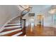 Grand curved staircase with wrought iron railing at 8919 Clavemorr Glenn Ct, Charlotte, NC 28226