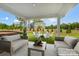 Relaxing covered patio with seating area and fire pit overlooking backyard at 9835 Quercus Ln, Huntersville, NC 28078