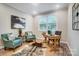 Home office featuring a wooden desk, two armchairs, and a cowhide rug at 9839 Quercus Ln, Huntersville, NC 28078