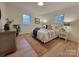 Spacious bedroom with plush bedding, a jute rug, and two nightstands at 106 Greentree Dr, Mount Holly, NC 28120