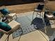 Relaxing patio with four wicker chairs and a patterned rug at 2521 Crimson Way, Monroe, NC 28112