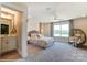 Bedroom with adjoining bathroom and wicker chair at 5124 Heathland Dr # 78, Charlotte, NC 28215