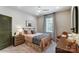 Bedroom with a queen bed, nightstands, and a desk with chair at 5124 Heathland Dr # 78, Charlotte, NC 28215