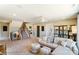 Spacious bonus room with L-shaped sofa and stairs at 5124 Heathland Dr # 78, Charlotte, NC 28215