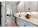 Butlers pantry with white cabinets, wine rack, and under-counter beverage cooler at 5124 Heathland Dr # 78, Charlotte, NC 28215