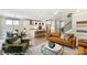 Living room with hardwood floors, leather couch, and a fireplace at 5124 Heathland Dr # 78, Charlotte, NC 28215