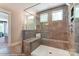Spacious walk-in shower with gray tile and built-in seat at 5124 Heathland Dr # 78, Charlotte, NC 28215