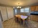 Bright dining area with wood table and chairs, adjacent to kitchen at 604 Eastwood Dr, Albemarle, NC 28001