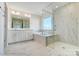 Bathroom with soaking tub, double vanity, and walk-in shower at 2024 Embassy Ct # 49, Charlotte, NC 28213